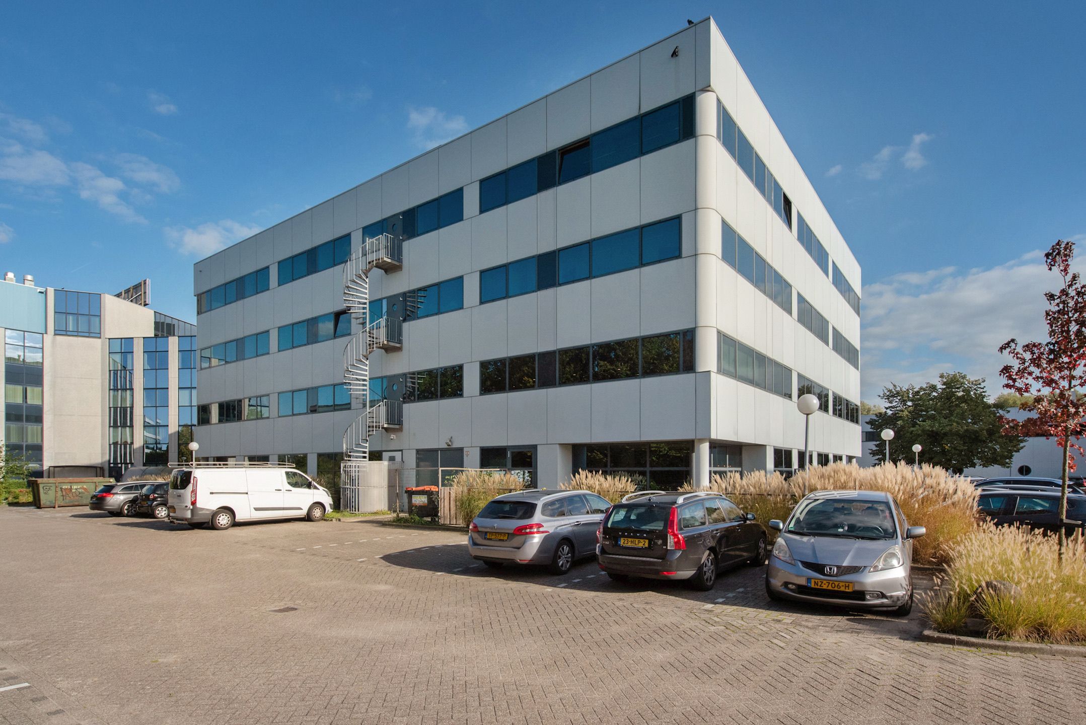 The Fleminglaan 12 office building in Rijswijk, seen from the car park on a clear day.